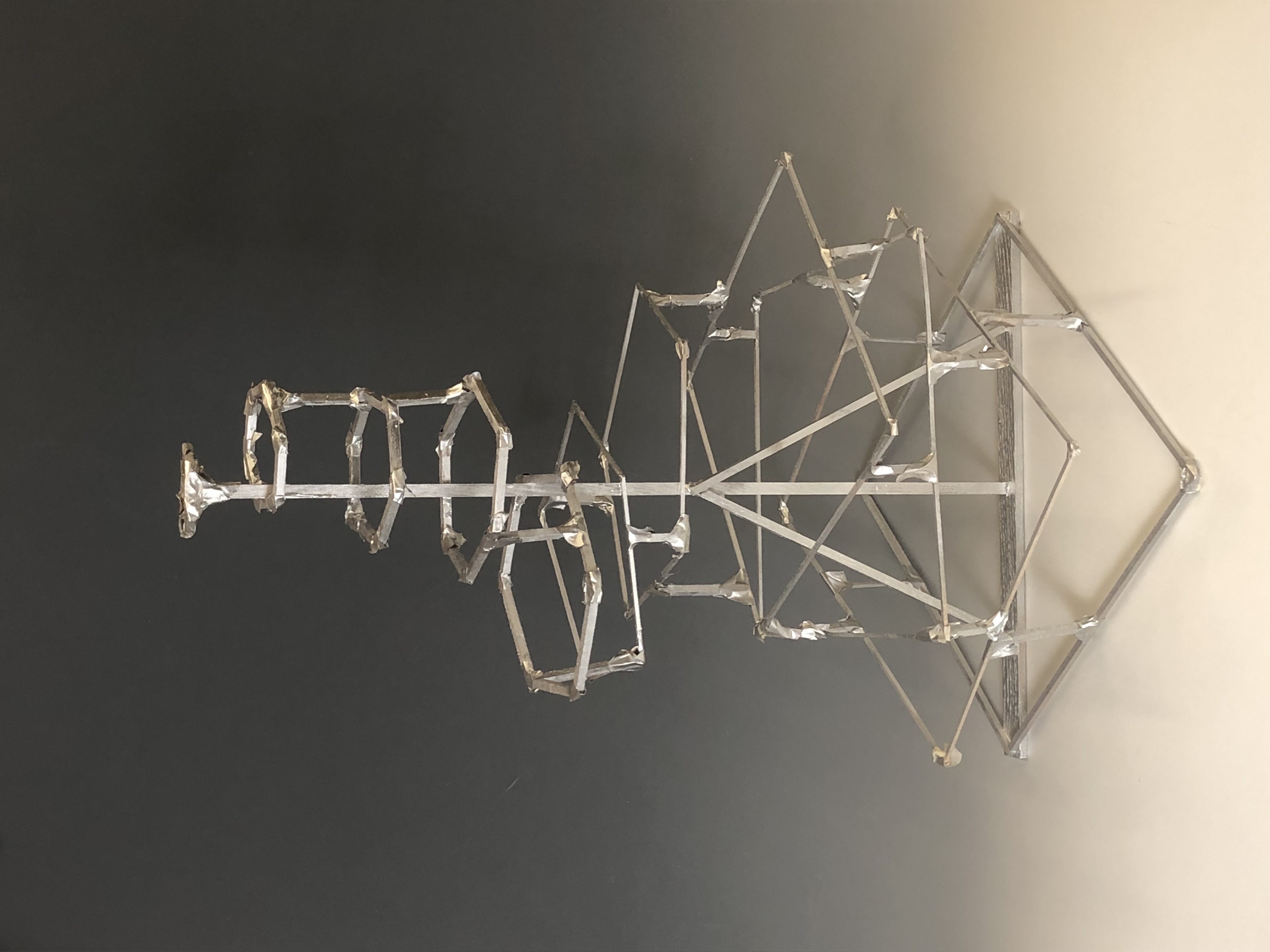 Balsa wood sculpture spray painted silver resembling a futuristic antenna